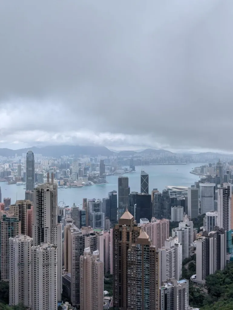Hong Kong Island's towers and Victoria Harbour seen from the Peak under low cloud