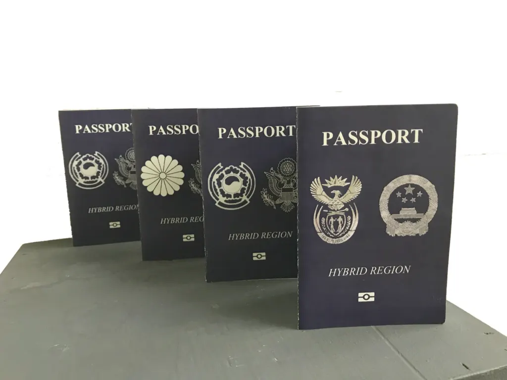 Four dark blue passports for the Hybrid Region, mixing South African and Chinese coats of arms