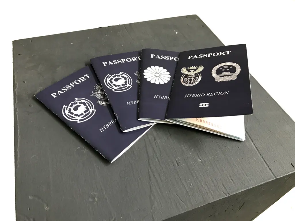 Hybrid Region passports fanned out on a grey plinth