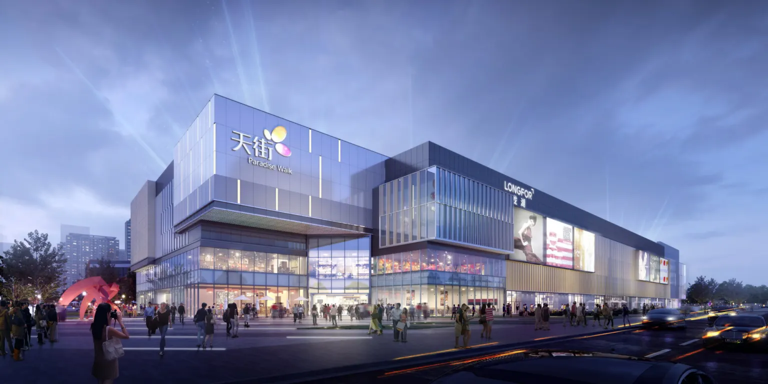 Night render of Shenyang Mall's southwest entrance, a glass and metal facade with beams of light above it